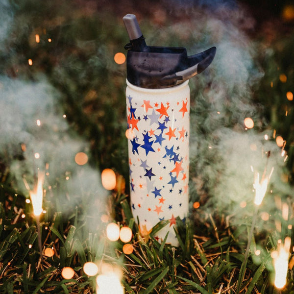 27 oz. SIC® Falling stars Water Bottle in grass with sparklers