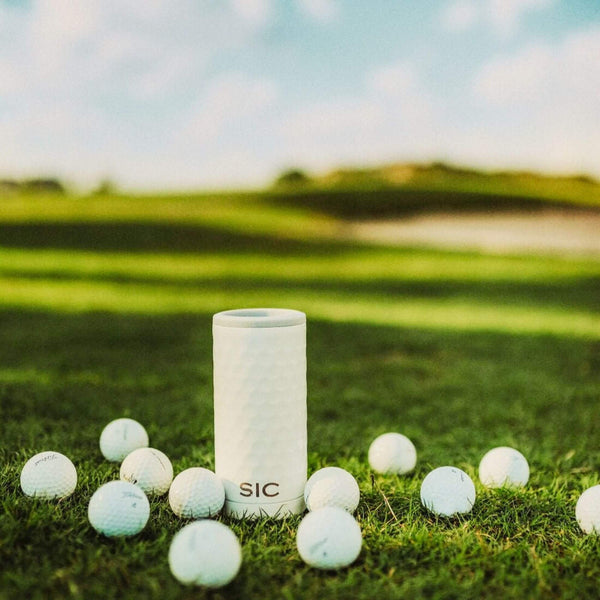 Dimpled Golf Slim Can Cooler on a putting green