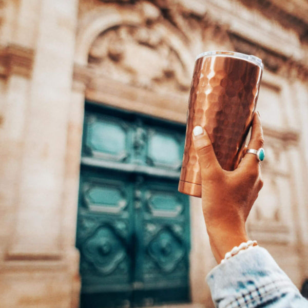 Woman Shopping while holding a SIC Hammered Copper Tumbler